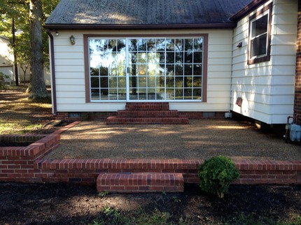 Marc’s on the Glass power pressure washing brick and stone patio with mold, moss, dirt