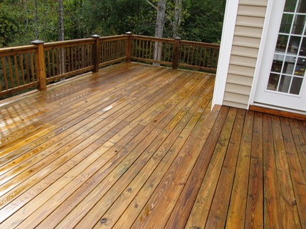 Marc’s on the Glass Pressure washing old deck with black and grey coloring, severe weathering, fully restored in Richmond, VA